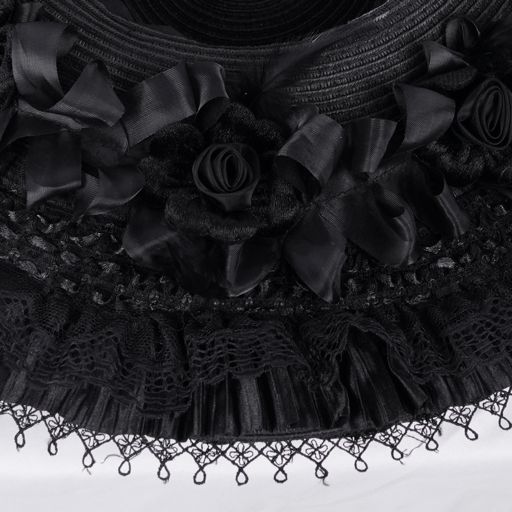 Close-up of gothic wide-brim hat featuring black lace, delicate ruffles, and intricate rose accents.