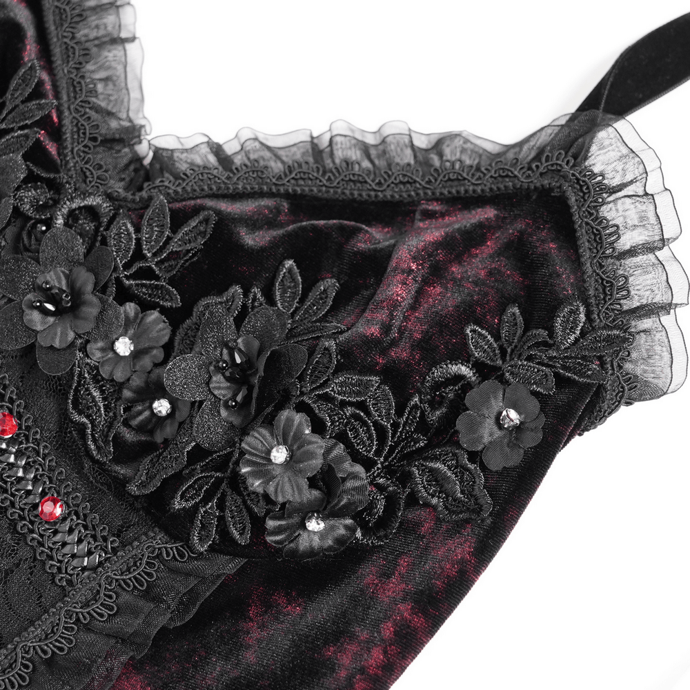 Close-up of floral lace and velvet detailing on a gothic halter dress showcasing black and wine red hues.