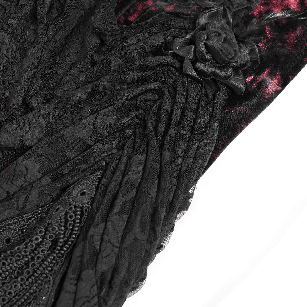 Close-up of detailed black lace and floral accents on a Gothic dress with velvet fabric.