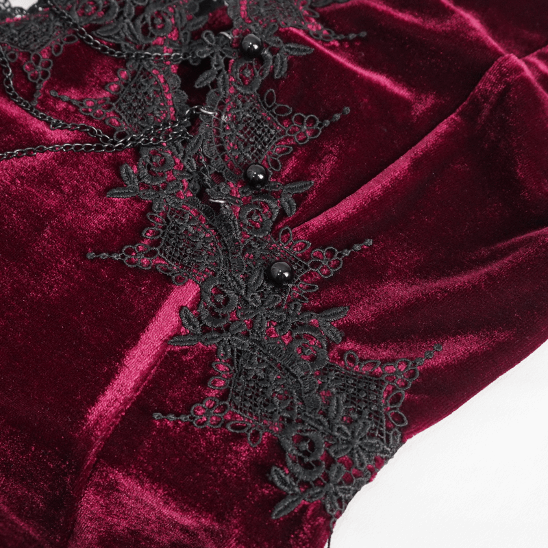 Close-up of gothic wine red velvet dress with black lace detailing and embellishments, showcasing elegant style.