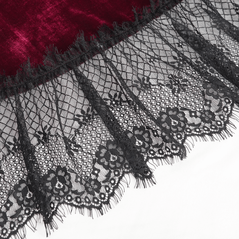 Close-up of black lace hem on a gothic wine red dress, showcasing intricate floral designs and elegant details.