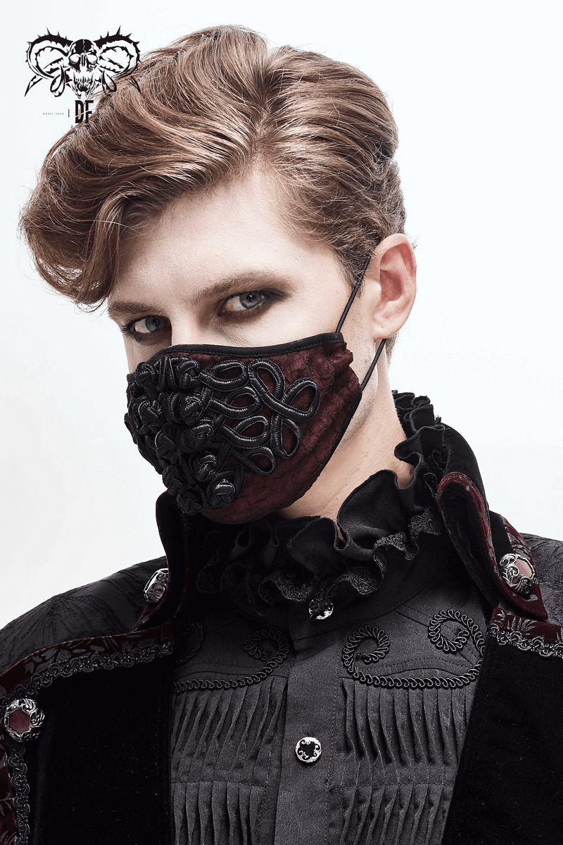 Gothic wine red mask with black embroidery, worn by a model in elegant attire.