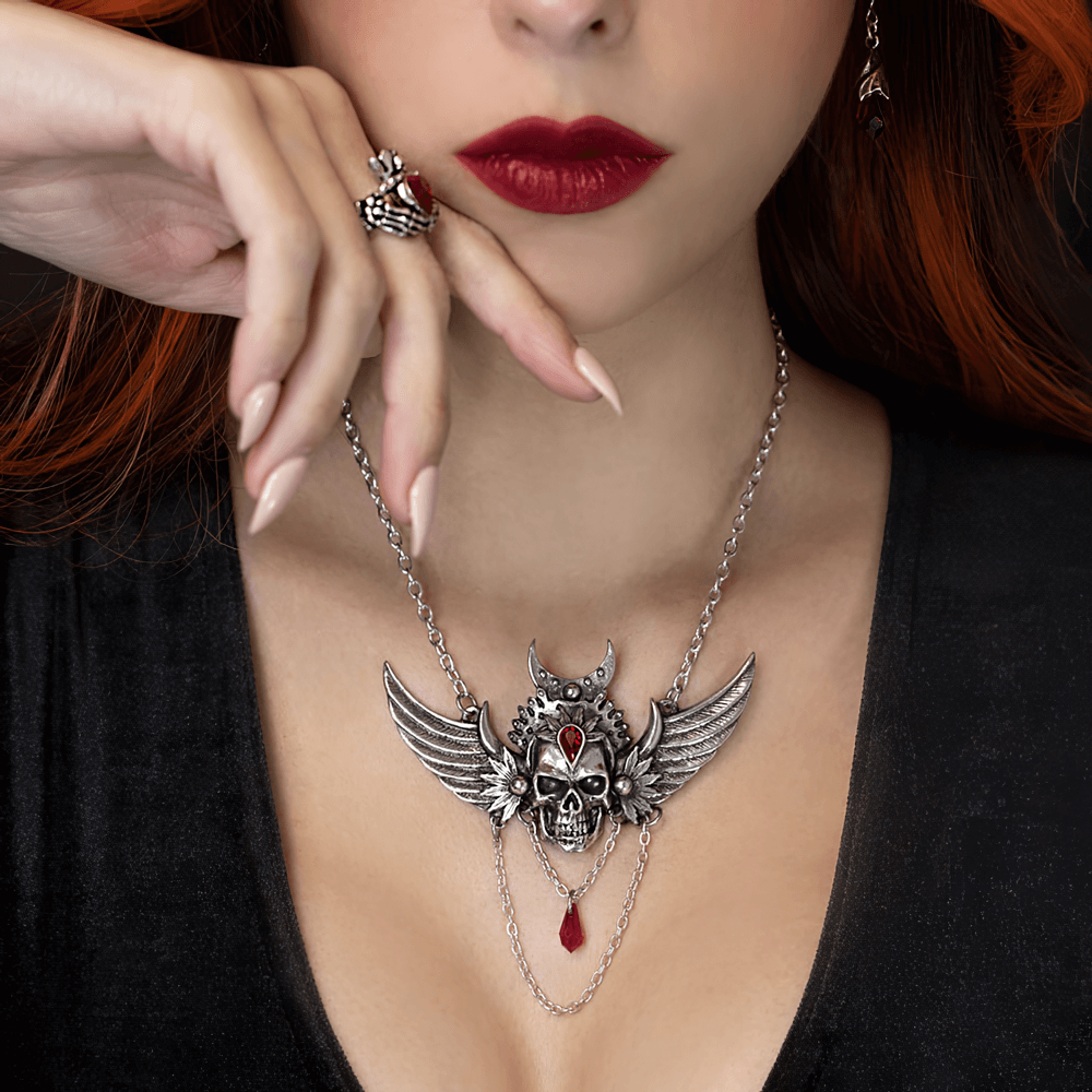 Gothic Winged Skull Necklace with Red Crystal Drop worn by model, showcasing dramatic skull design with Siam red crystal.