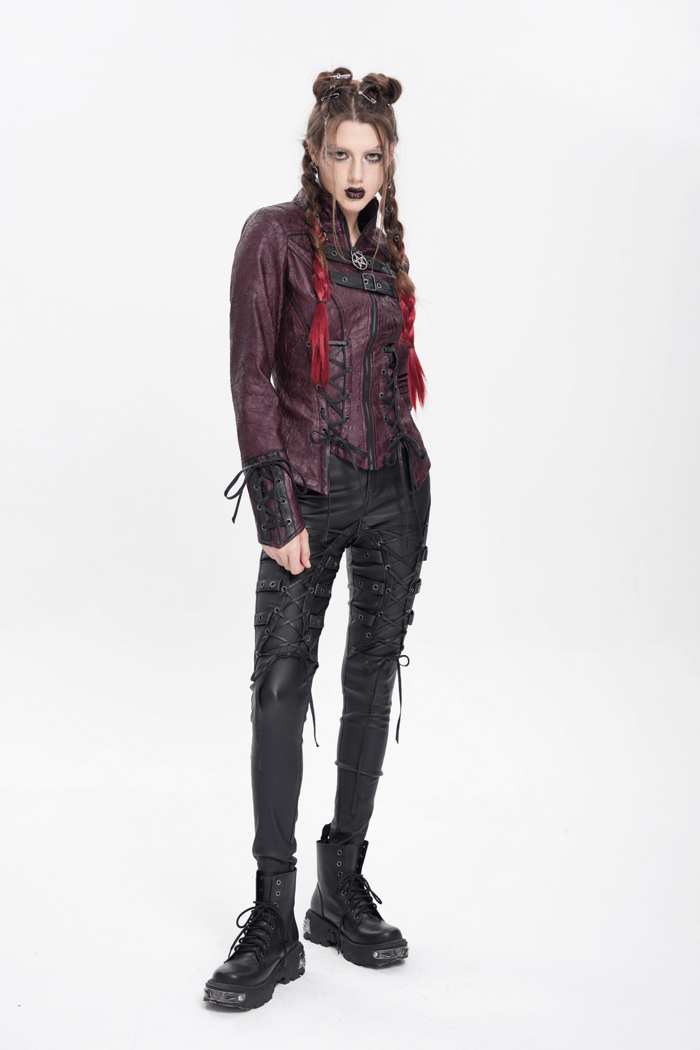 Gothic women's purple faux leather jacket with lace and buckles, styled with edgy black pants and combat boots.