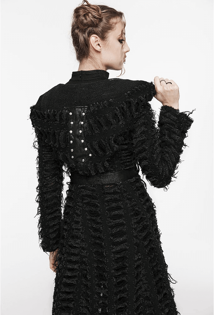 Back view of a woman in a Gothic black hooded cape with textured fabric and decorative buttons.