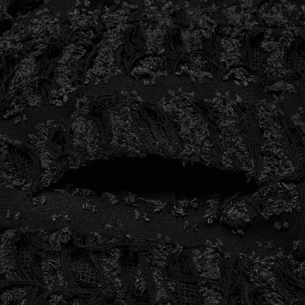 Close-up of textured black fabric featuring distressed twill and mesh elements for a Gothic cape look.