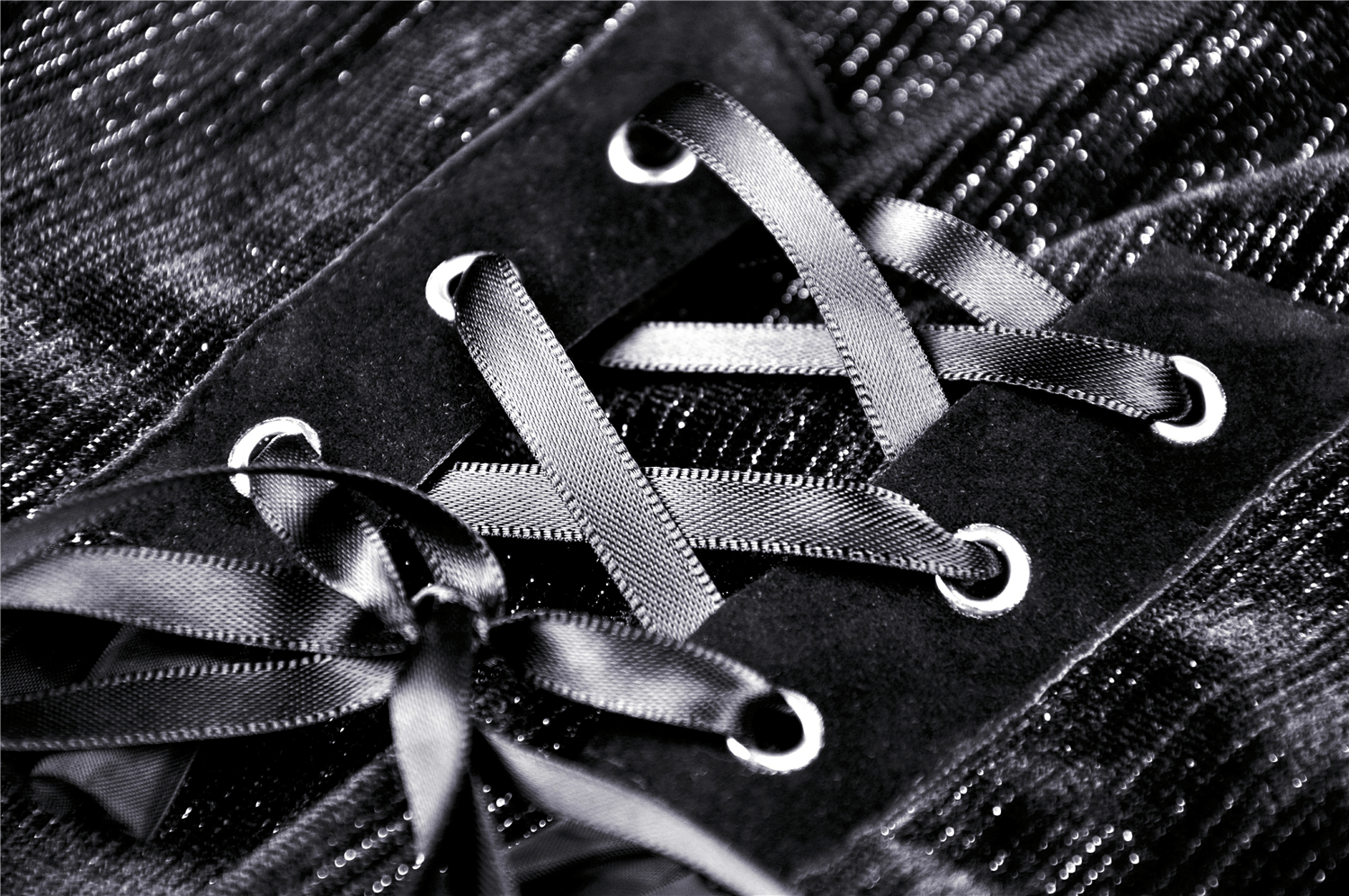 Close-up of gothic mini dress lacing with black ribbons and intricate details, perfect for a dark aesthetic look.