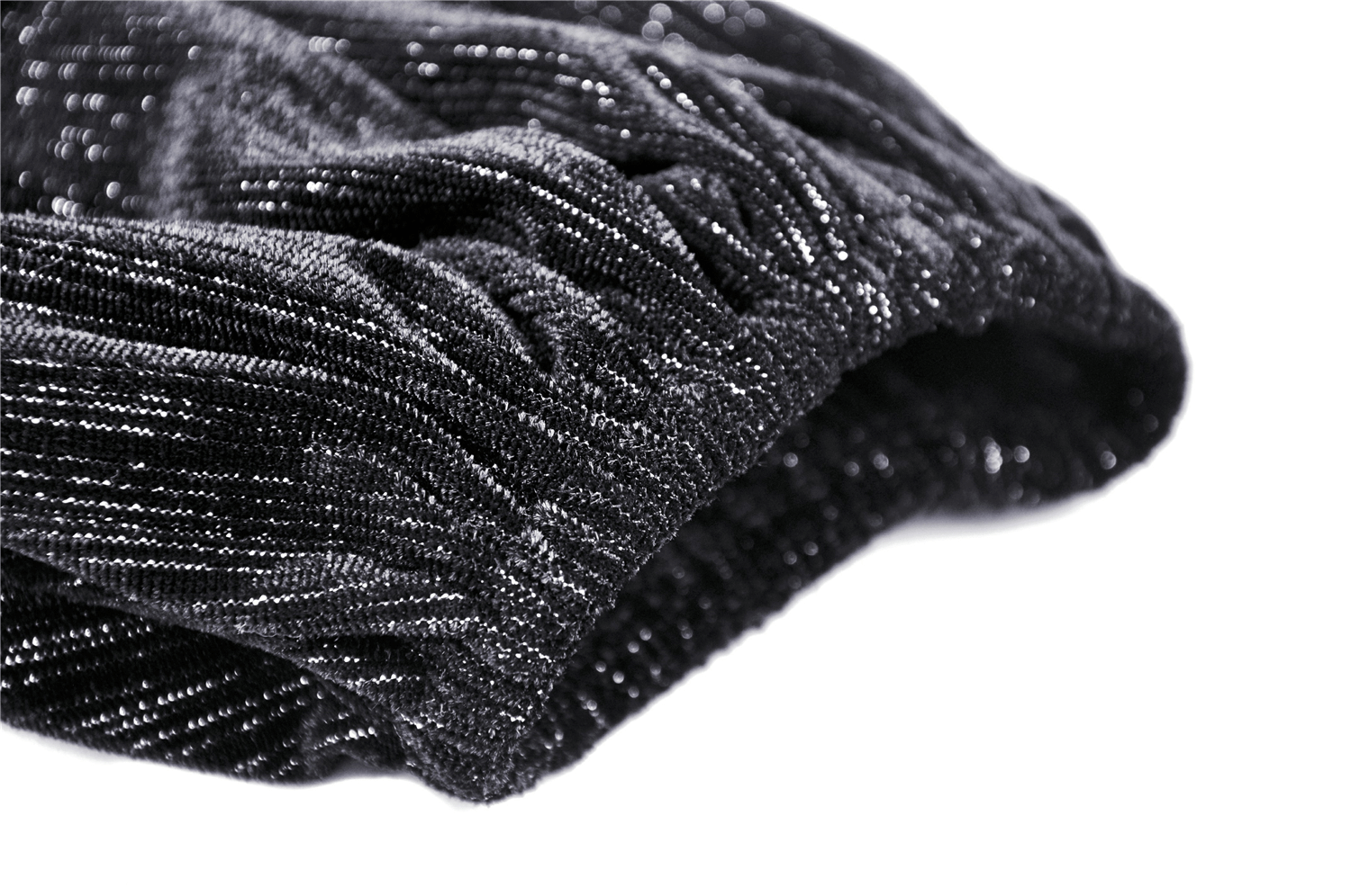 Close-up of gothic black lace fabric featuring elegant shimmering texture and intricate detailing.