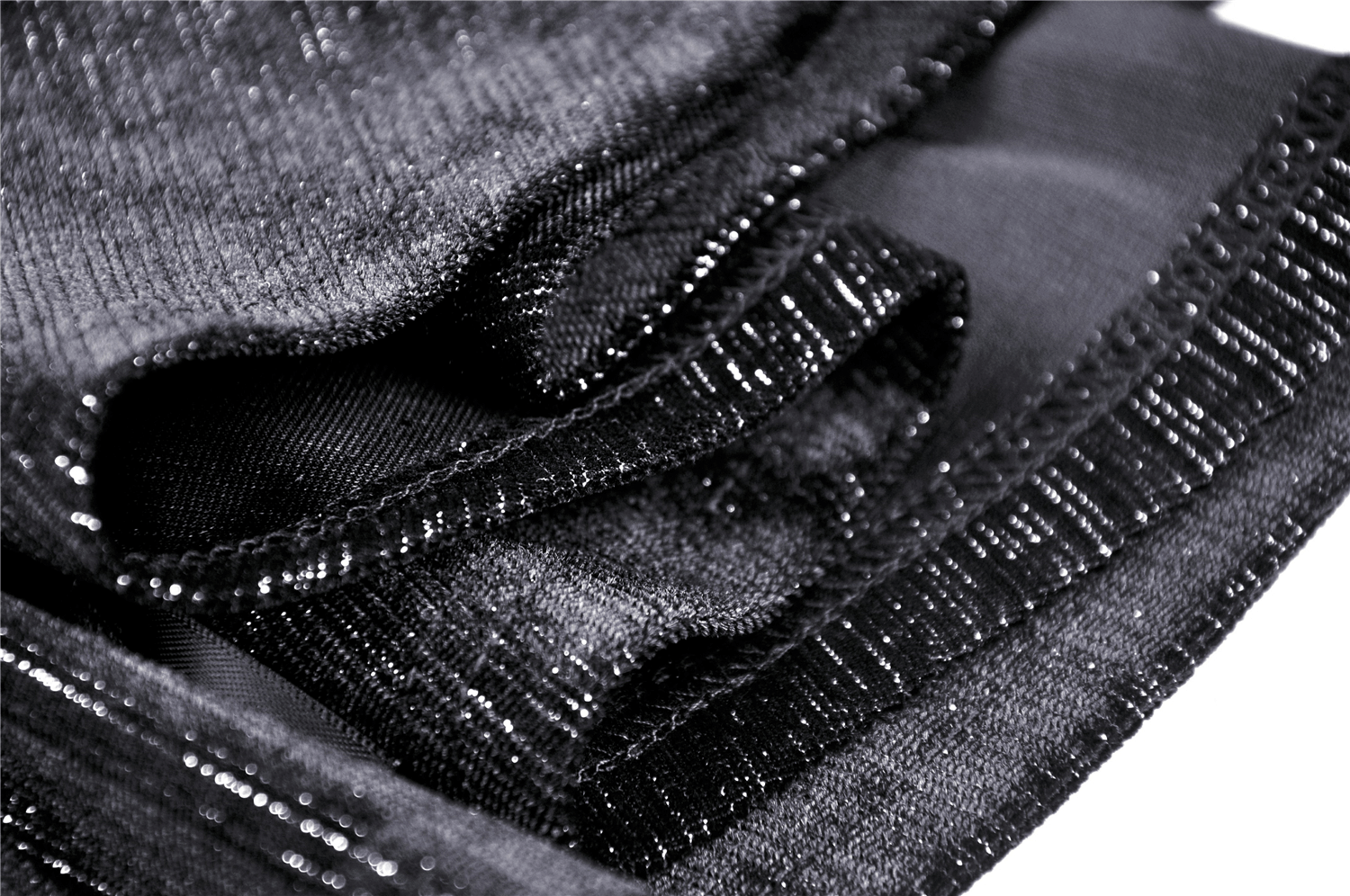 Close-up of elegant black lace fabric showcasing intricate textures and shimmering details.
