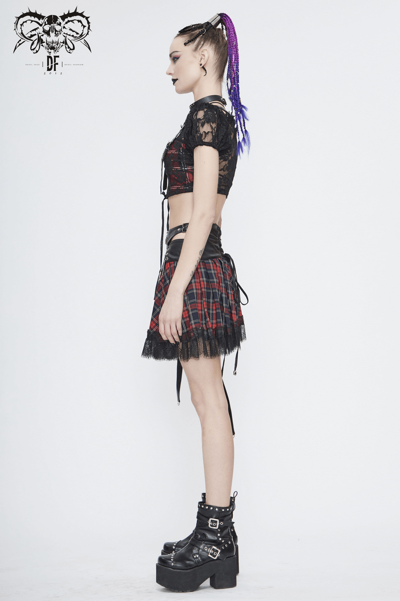 Side view of a model in a gothic black and red plaid crop top with lace, paired with a matching skirt and platform boots.
