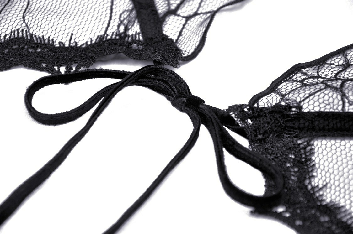 Close-up of delicate black lace with a soft bow detail, perfect for elegant gothic outfits.