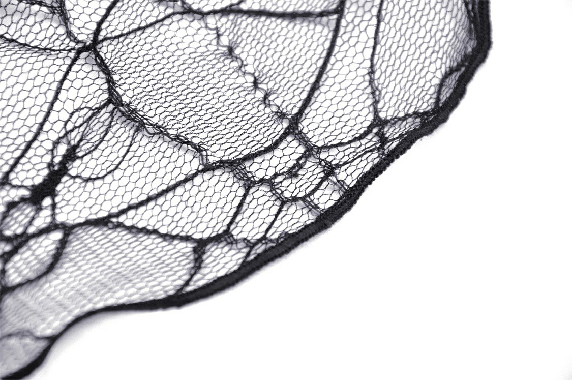 Close-up of delicate black lace fabric featuring an elegant spider web design for gothic fashion.