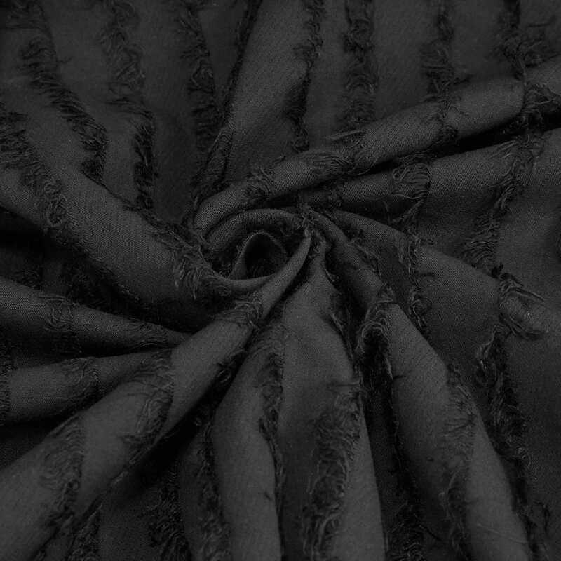 Close-up of textured black fabric featuring gothic-style frayed details, perfect for a trendy women's blouse.