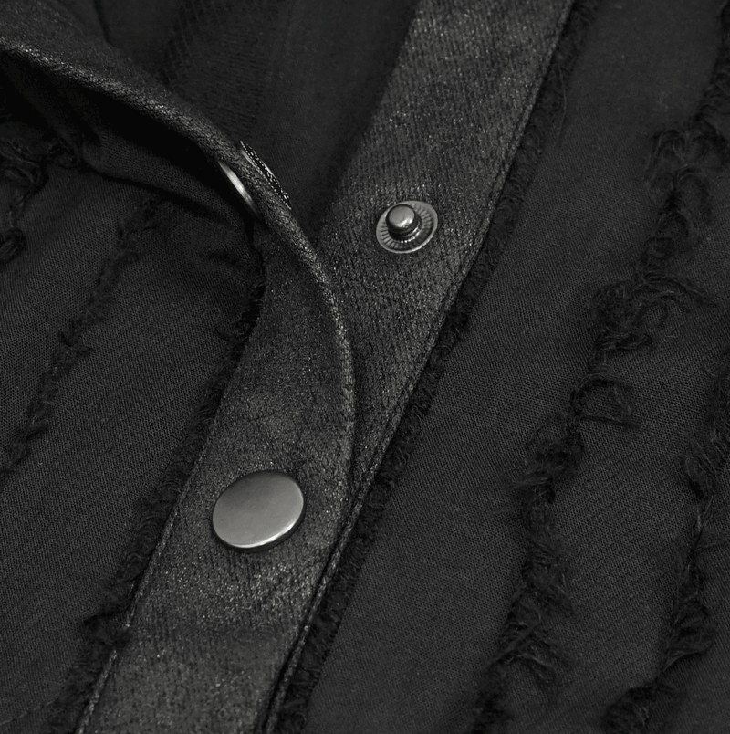 Close-up of a gothic women's black short sleeve blouse with stylish silver buttons and textured fabric details.