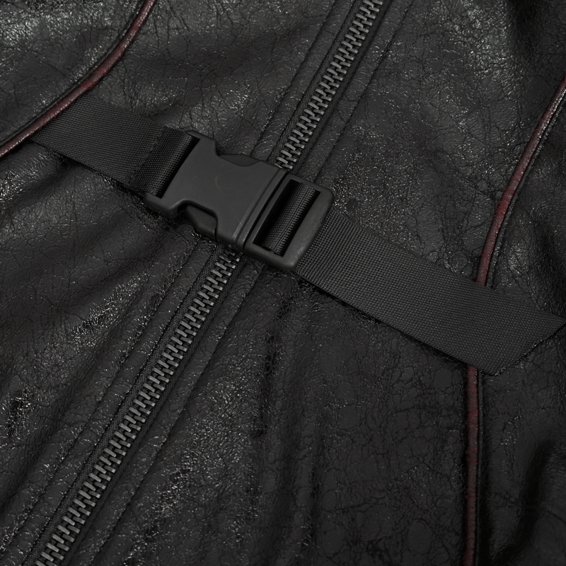 Close-up of buckle straps and zipper on a gothic women's faux leather coat, showcasing edgy design elements.
