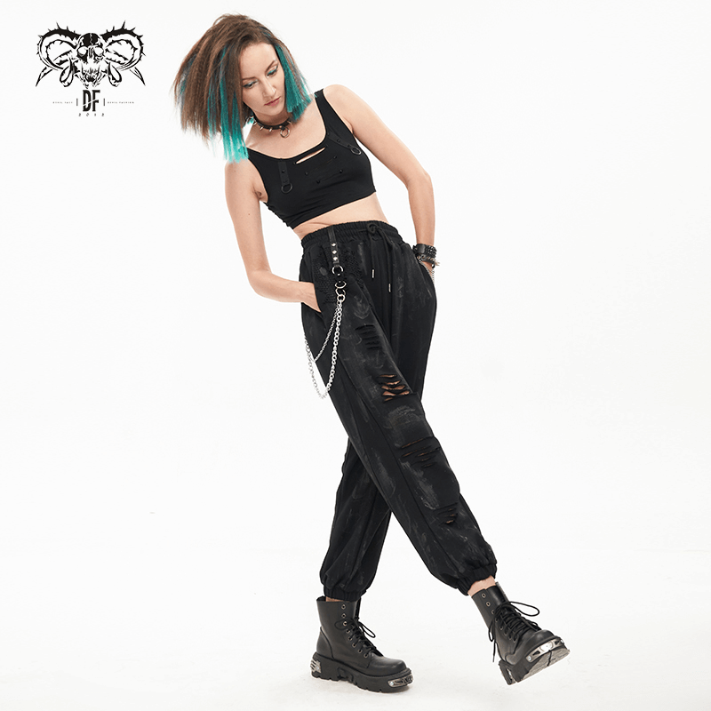 Trendy gothic woman in black elastic waist cargo pants with chains and rivets, showcasing a stylish loose fit.