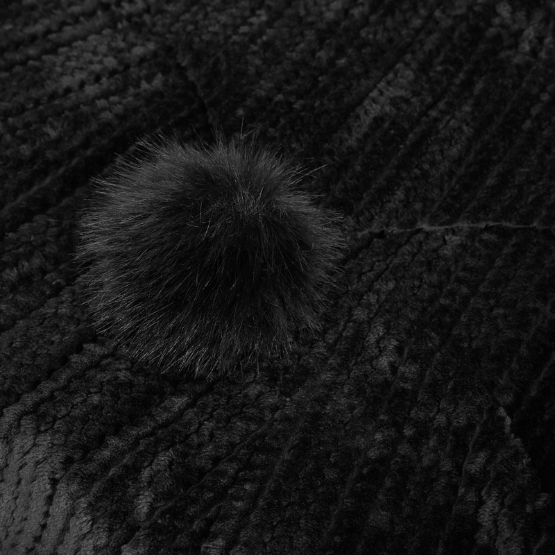 Close-up of a soft black fluffy coat featuring a chic fur pom-pom accent for a gothic vintage style.