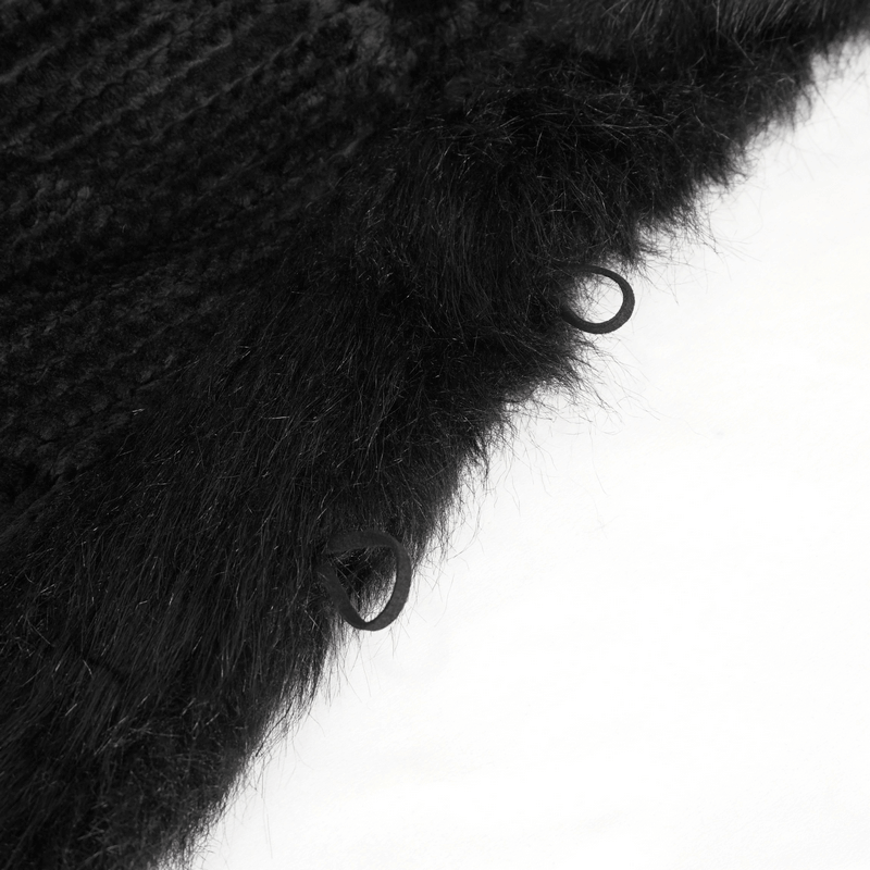 Close-up of the fluffy black fabric and fastening details of a gothic hooded cape coat.