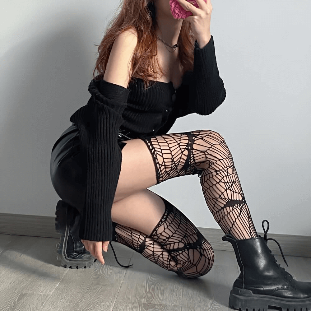Gothic women's bat fishnet pantyhose paired with a black outfit, showcasing edgy cosplay style.