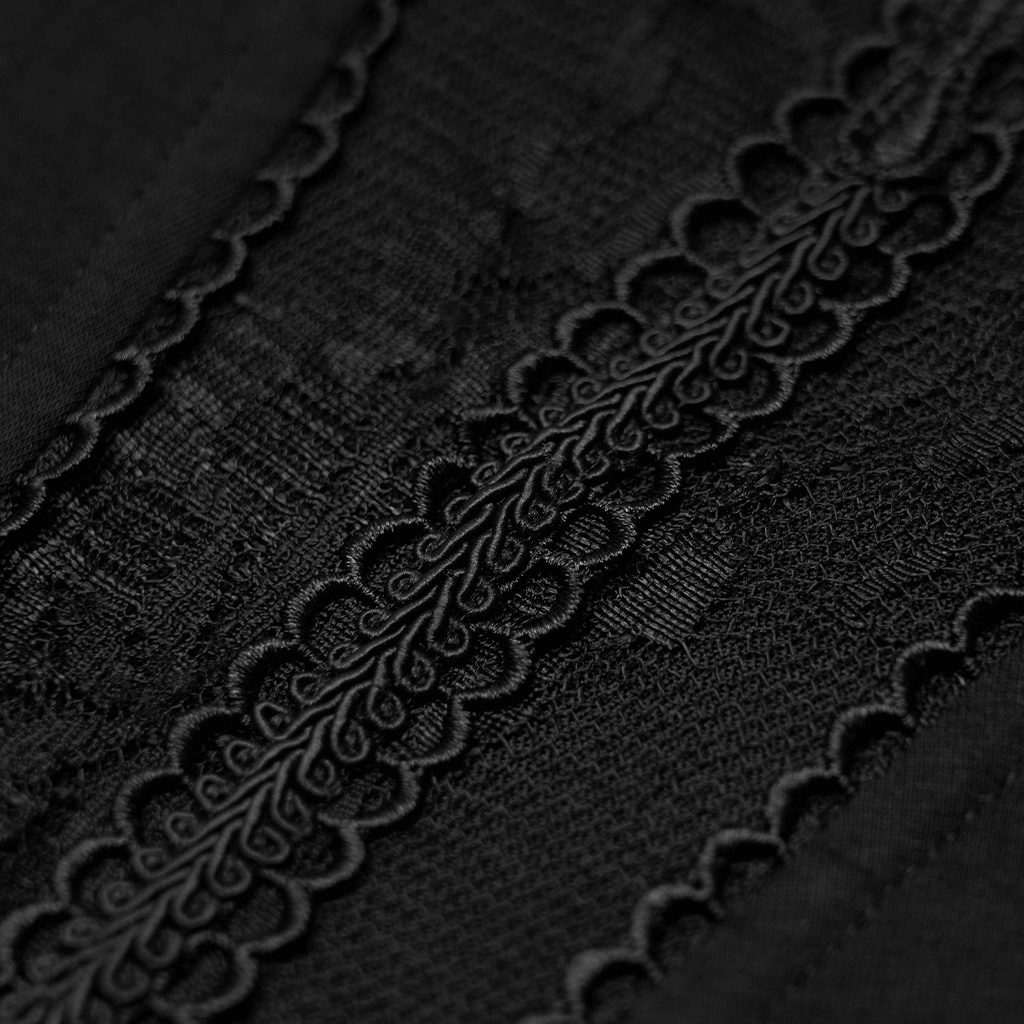 Close-up of black fabric featuring intricate lace detail, showcasing gothic style elegance and vintage charm.