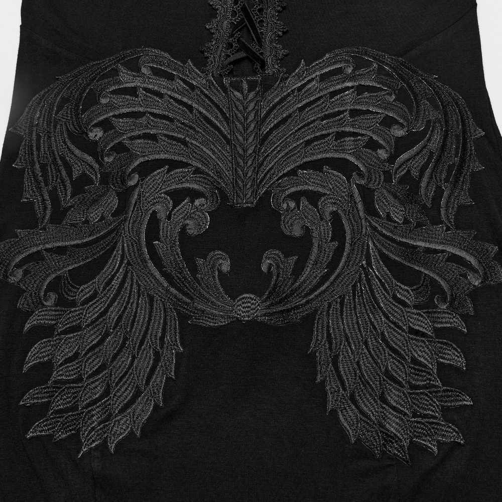 Intricate black embroidery on a gothic dress featuring bold wing patterns and elegant detailing.