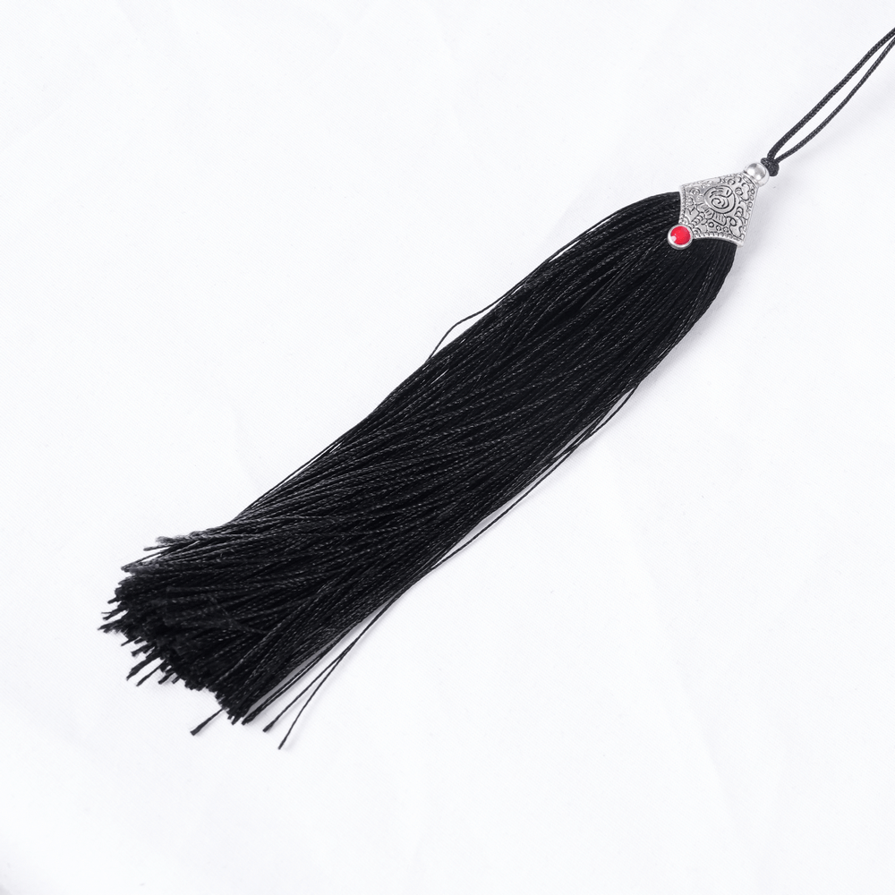 Black tassel detail with silver accent and red gem, perfect for gothic fashion accessories.
