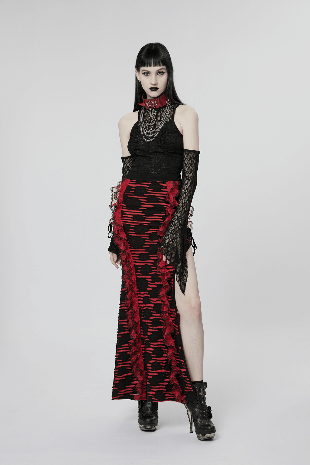 Gothic women's lace drawstring top with flared cuffs, paired with a bold red and black skirt. Edgy punk fashion look.