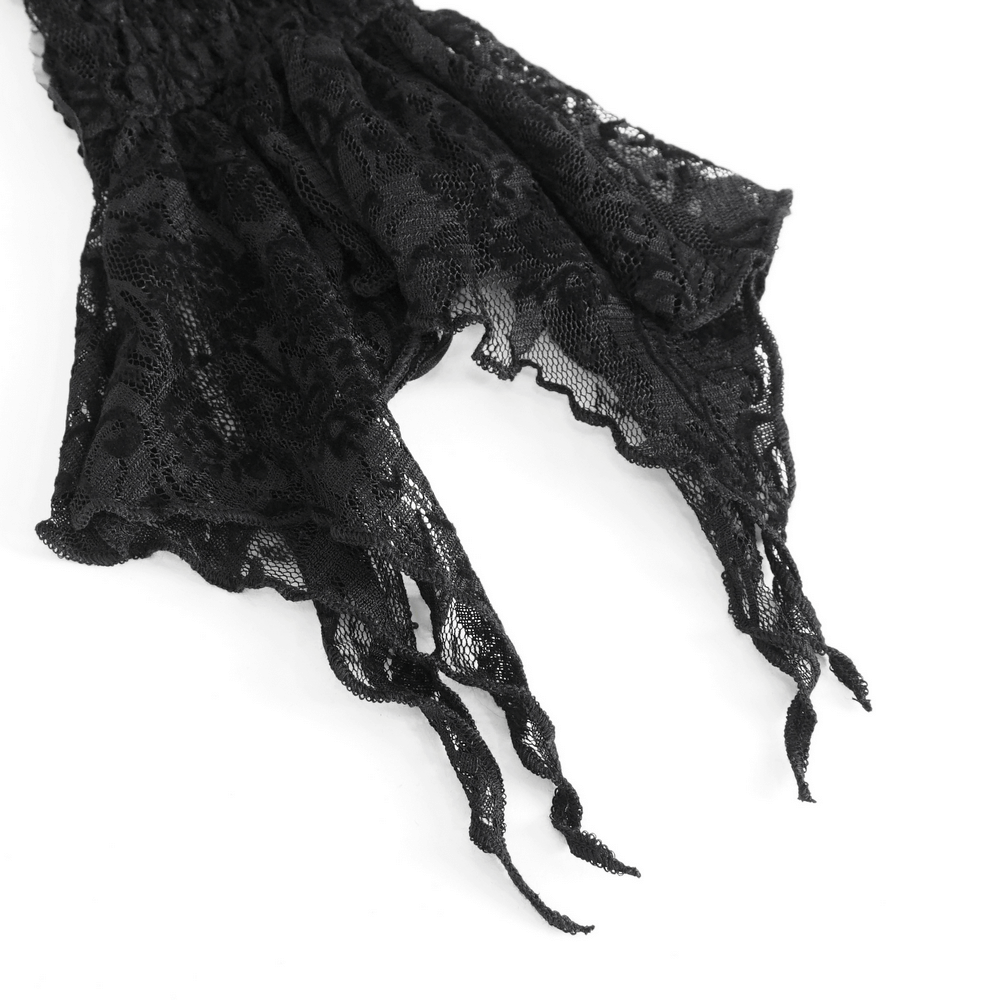 Close-up of gothic black lace fingerless gloves with cascading feather details.