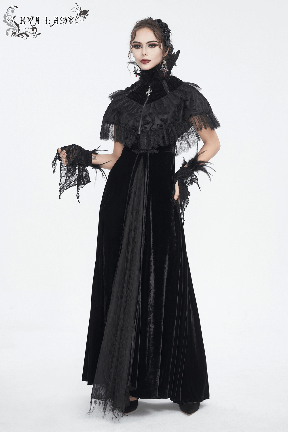 Gothic woman in elegant black velvet dress with lace details and fingerless gloves, showcasing a dramatic gothic style.