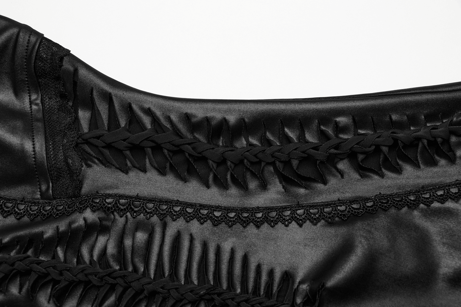 Close-up of the intricate lace-up back detail on a black gothic dress, showcasing braided and scalloped textures.