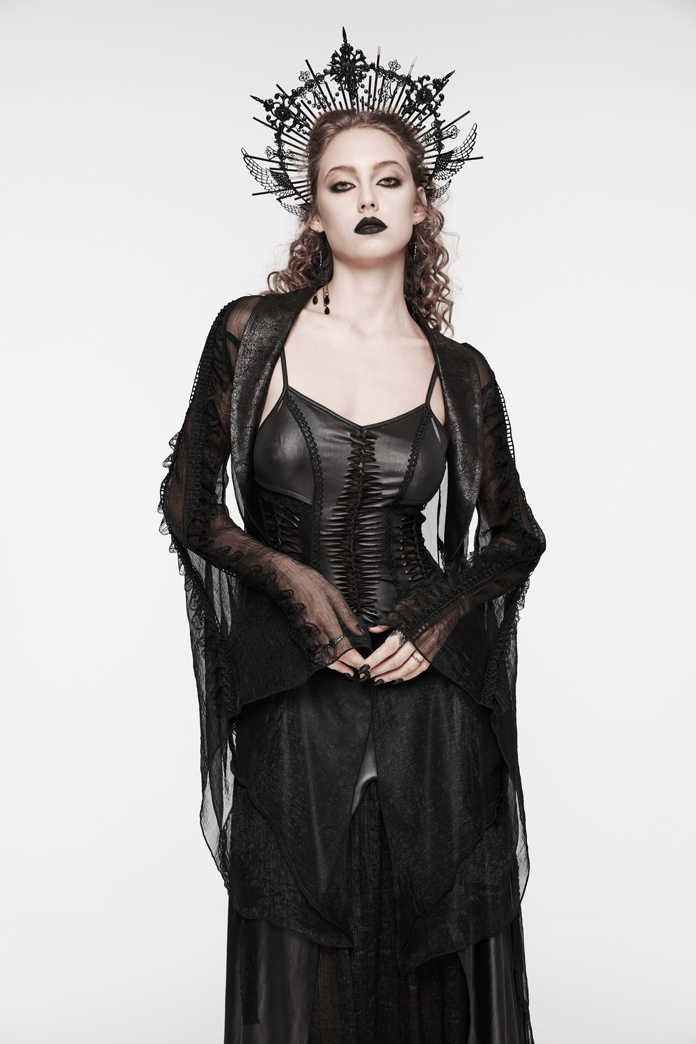Gothic woman in black lace dress and crown, exuding dark elegance and style.