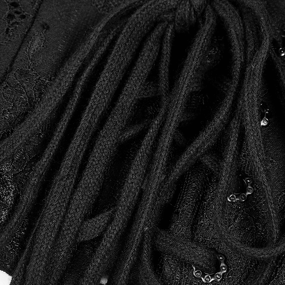 Close-up of a gothic black lace corset's lace-up details with feather accents and decorative eyelets.