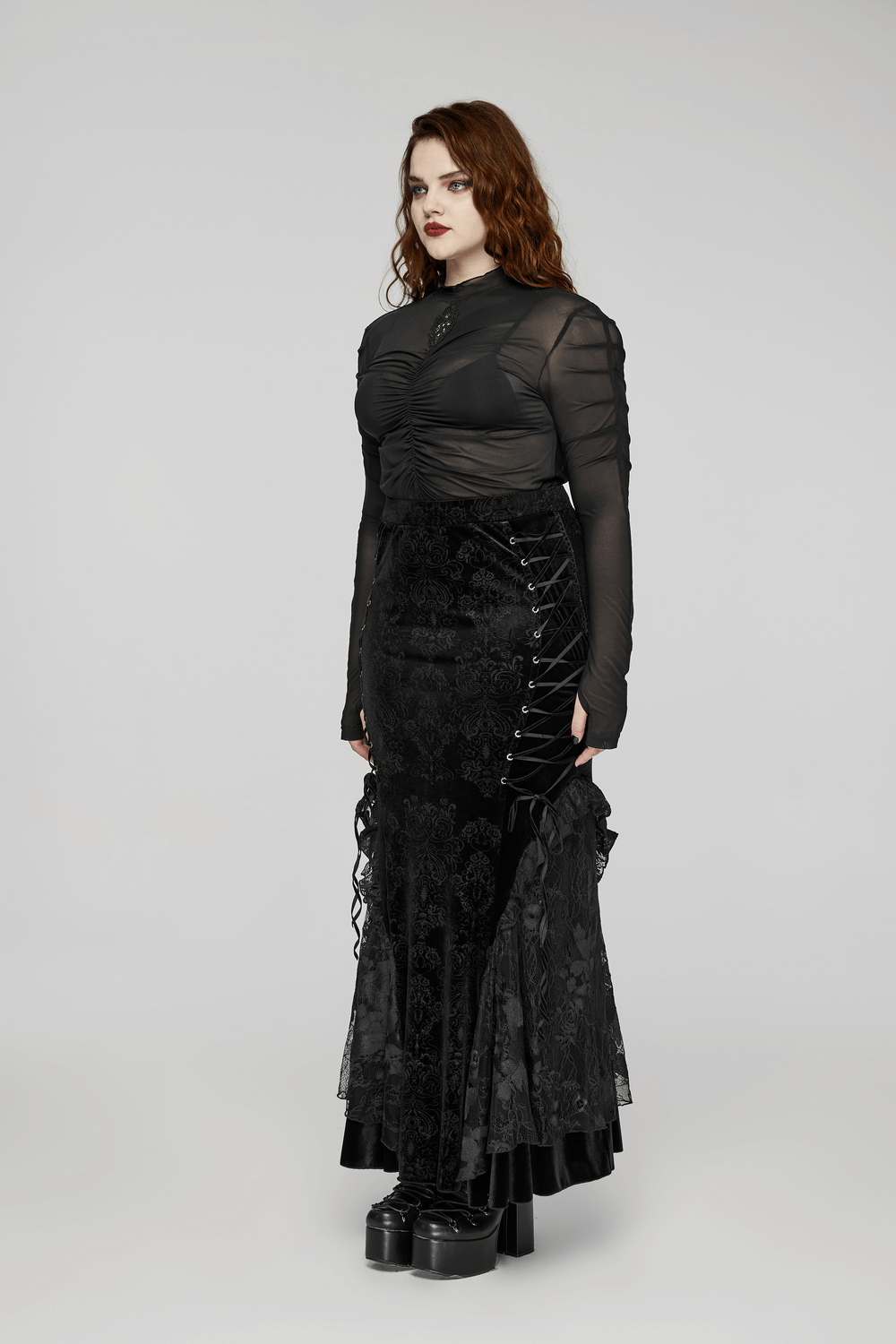 Gothic women's lace-up embossed velvet fishtail skirt paired with a sheer black long sleeve top, exuding punk elegance.