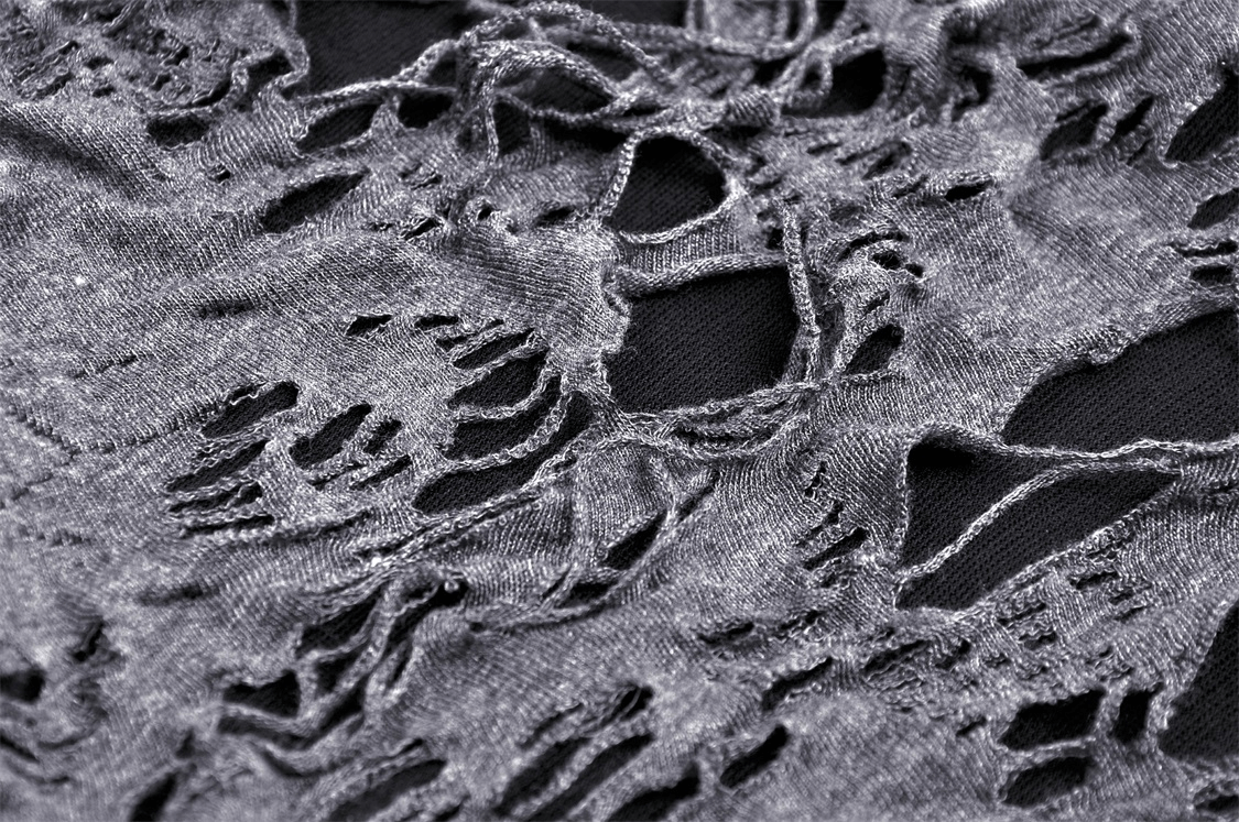 Close-up of edgy shredded fabric, showcasing stylish lace-up design for Gothic women's fashion.