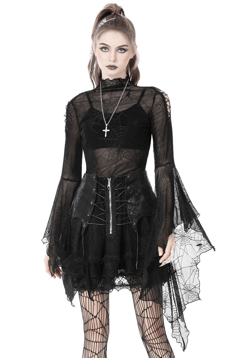 Gothic women's black mesh spiderweb top with long sleeves, layered over a stylish skirt, perfect for edgy fashion.