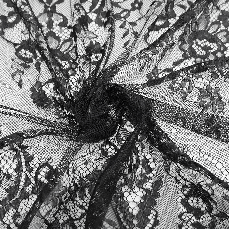 Close-up of intricate black lace fabric with floral patterns, perfect for Gothic-style clothing and elegant designs.