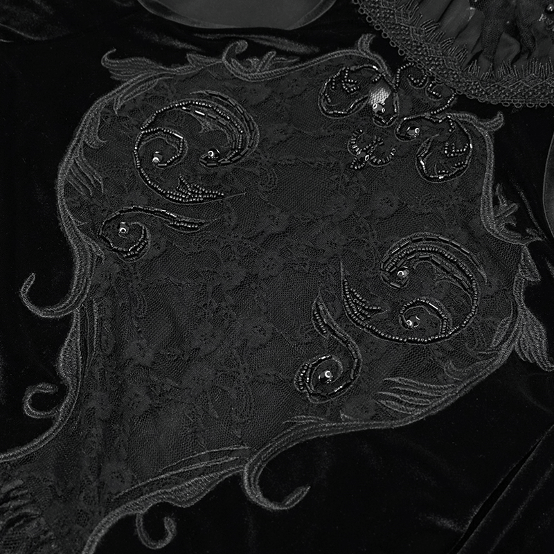 Close-up of elegant black velvet fabric with intricate lace and embellishments, showcasing Gothic style details.