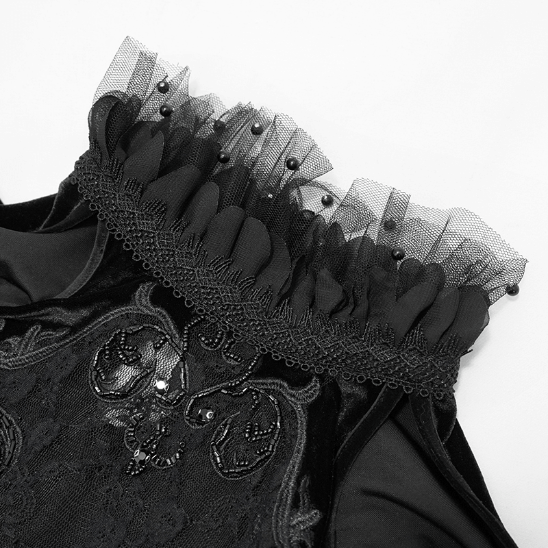 Close-up of black velvet off-shoulder dress neckline with delicate lace and tulle detailing for a gothic elegance.