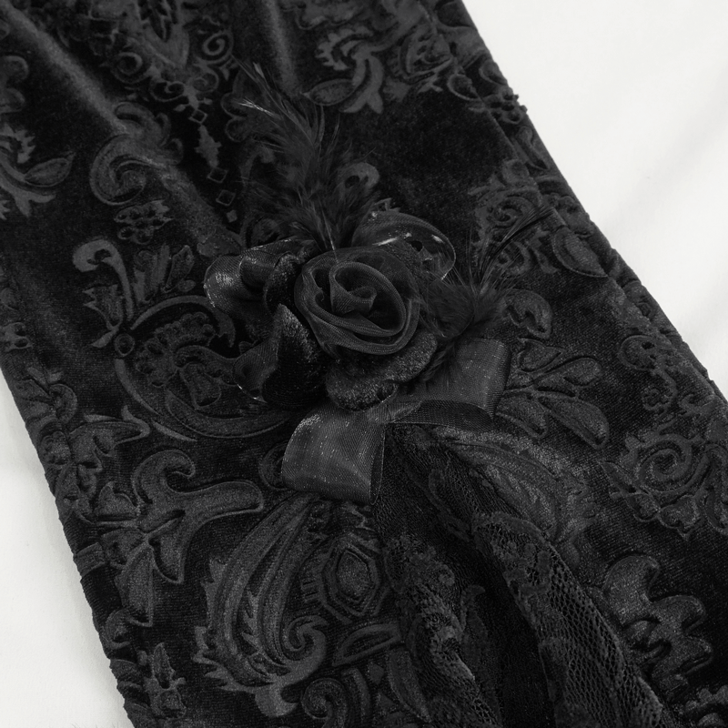 Close-up of elegant Gothic black lace fabric with flower and feather decoration.