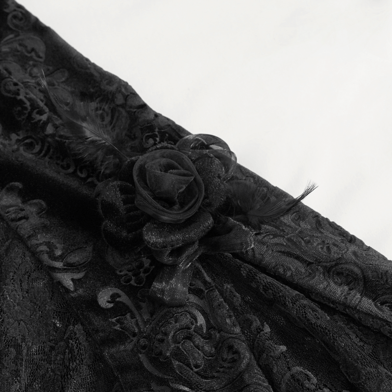 Close-up of elegant black lace fabric with a flower decoration, showcasing gothic style and intricate patterns.