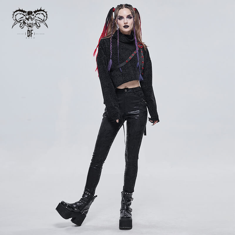 Gothic women's slim-fitted black pants with buckle accents, paired with a stylish black crop top, showcasing edgy fashion.