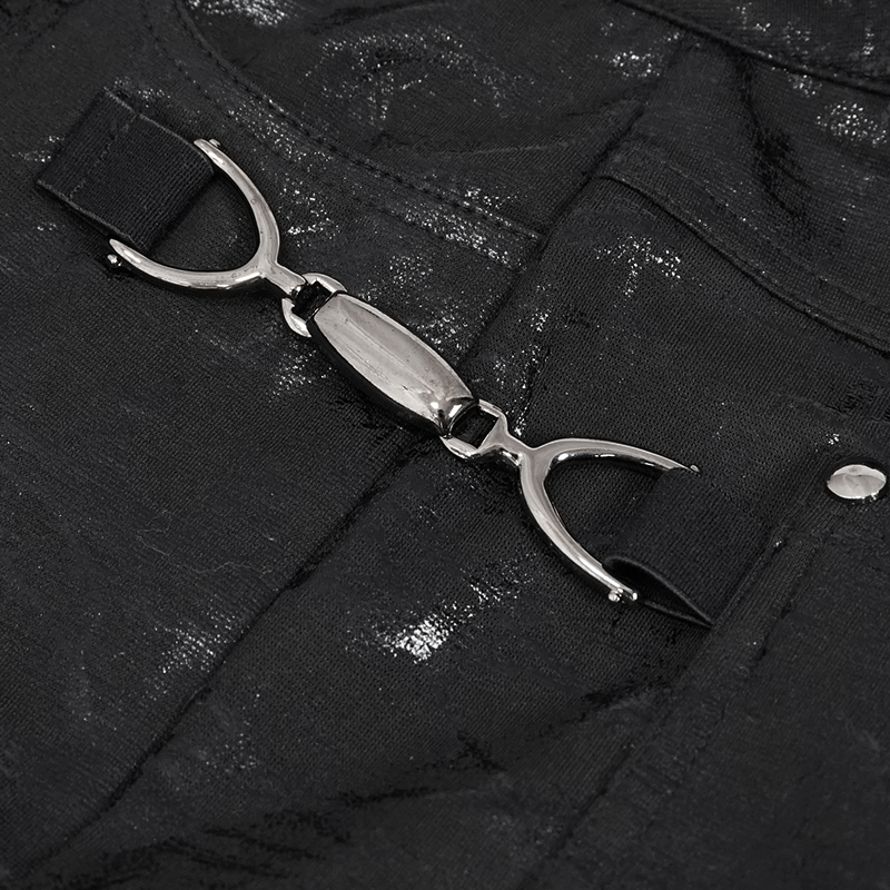 Close-up of buckle accents on black gothic women's slim-fitted pants, highlighting stylish design and details.