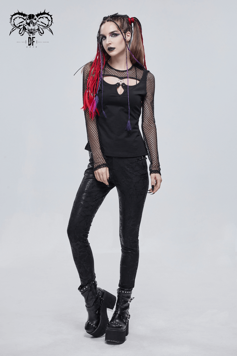 Gothic woman wearing black slim-fitted pants with buckle accents, styled with a mesh top and striking colorful hair.