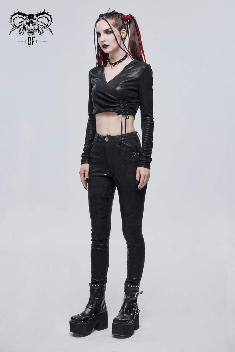Gothic women's black slim-fitted pants with buckle accents, paired with a stylish cropped top and platform boots.