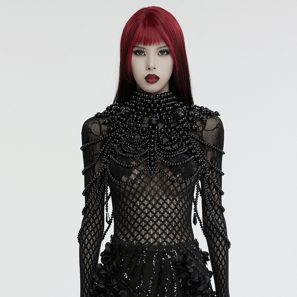 Gothic women's pearl body accessory adorned with black beads and a stunning skull centerpiece.