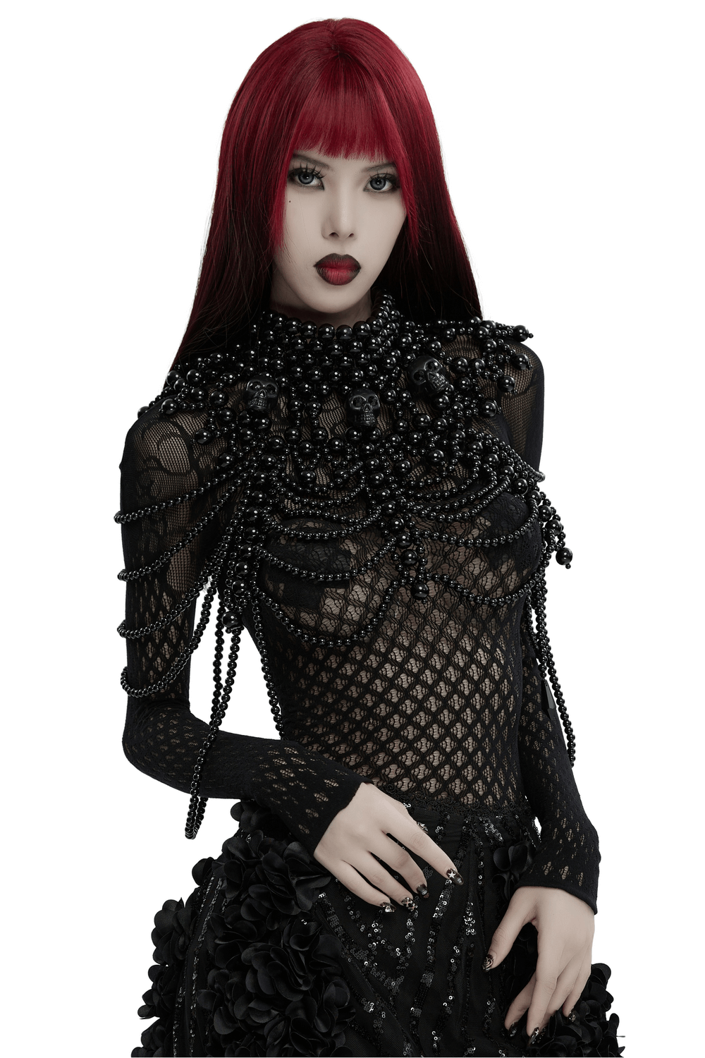 Gothic women's pearl body accessory with skull accents in elegant black attire.