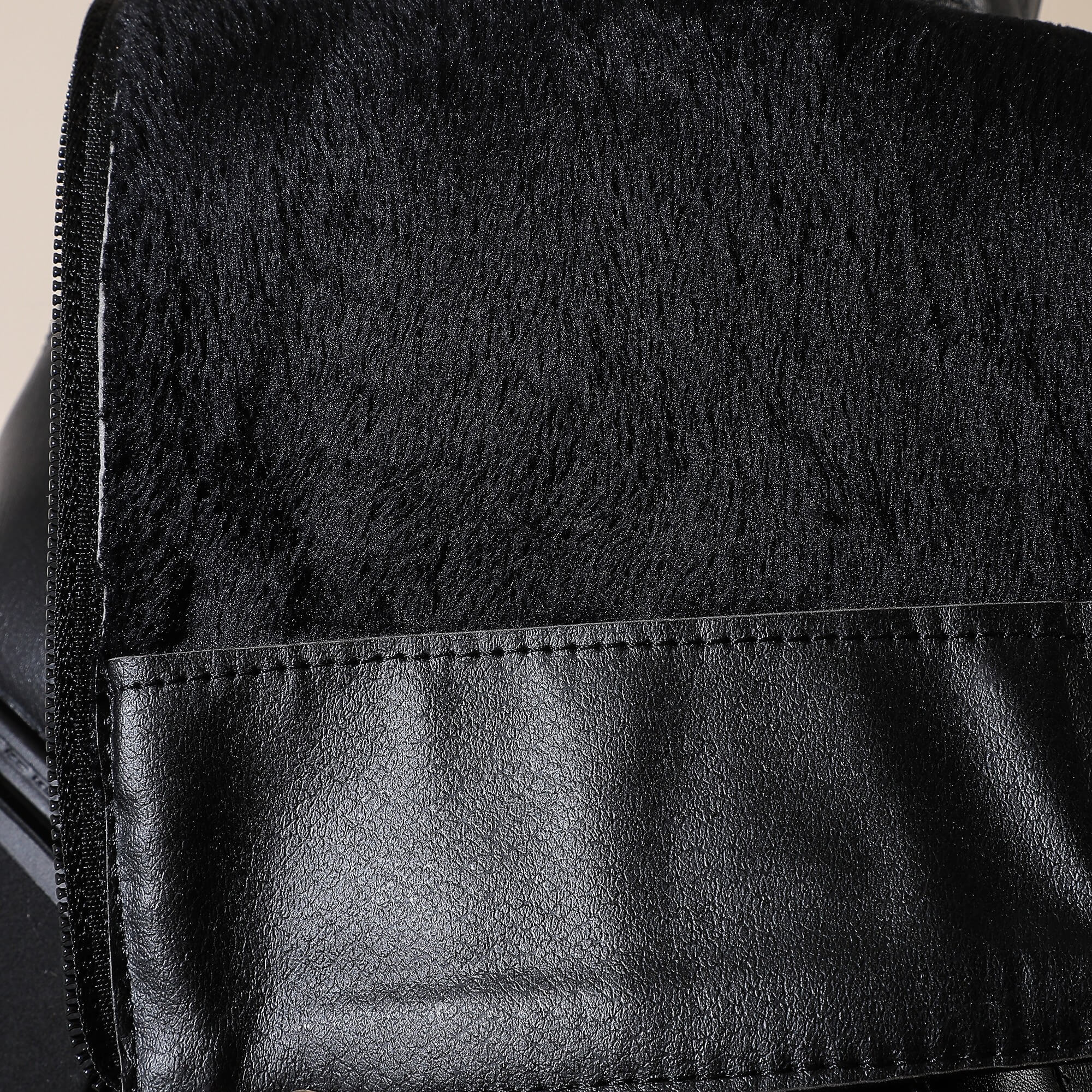 Close-up of black faux leather and fur texture of Gothic womens platform boots.