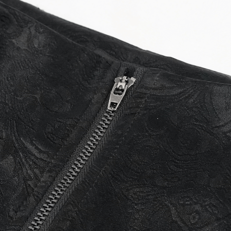 Close-up of gothic women's PU leather pants with metal zipper and textured black fabric detail.