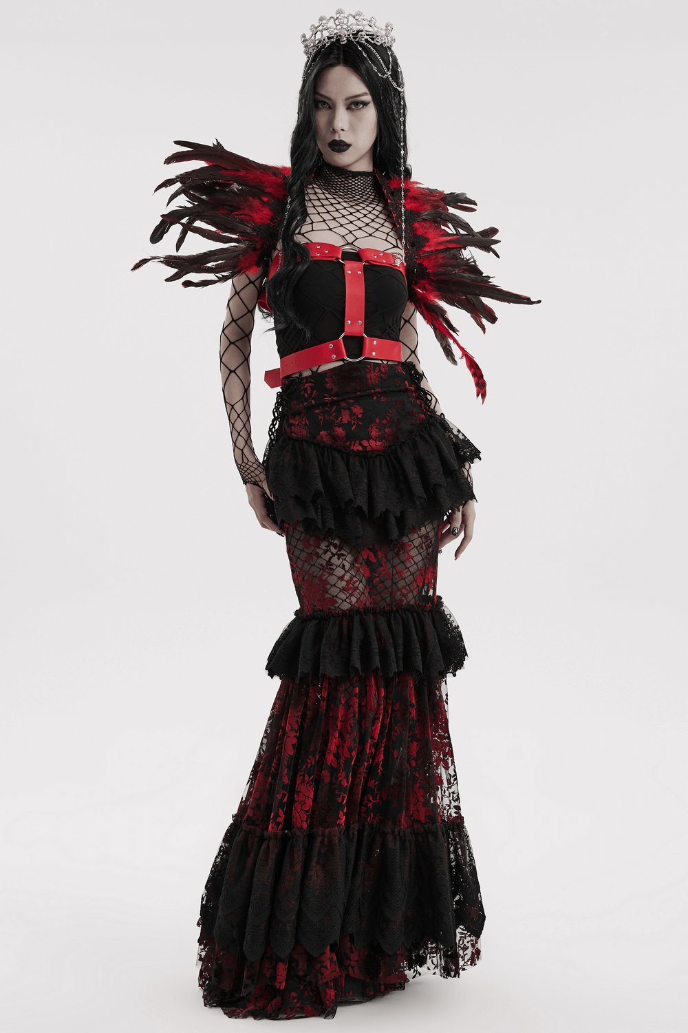 Gothic woman wearing dramatic black and red feather shoulder accessory with lace dress for Halloween or cosplay.