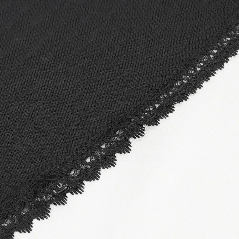 Close-up of intricate black lace trim against a soft white fabric background, showcasing gothic elegance.